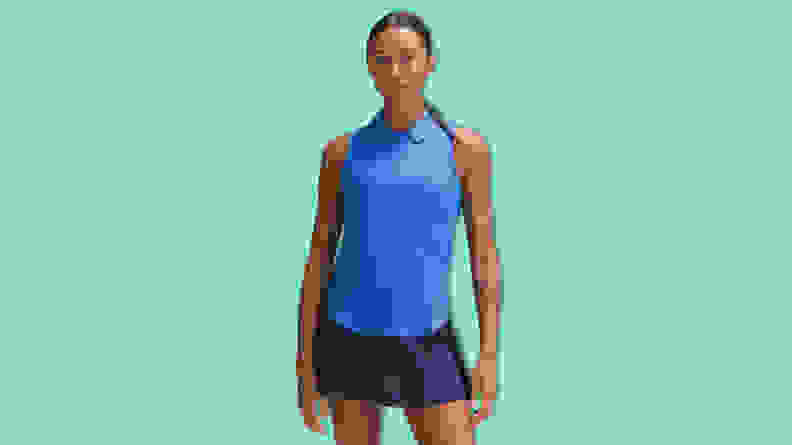 A woman wearing a blue lululemon Women's Swiftly Tech Short-Sleeve Half-Zip Polo Shirt on a teal background.