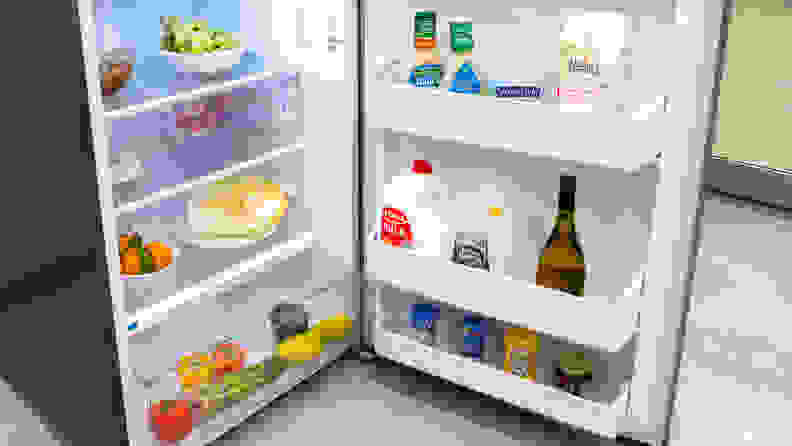 Peering into the main cavity of the Frigidaire FFHT1425VV,which is stocked with groceries.